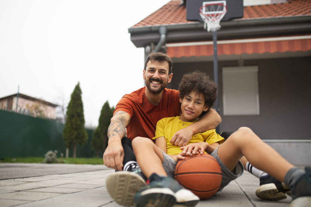 father-son-playing-basketball-together-backyard