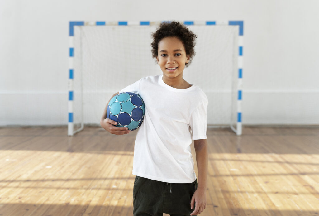 medium-shot-smiley-kid-holding-ball